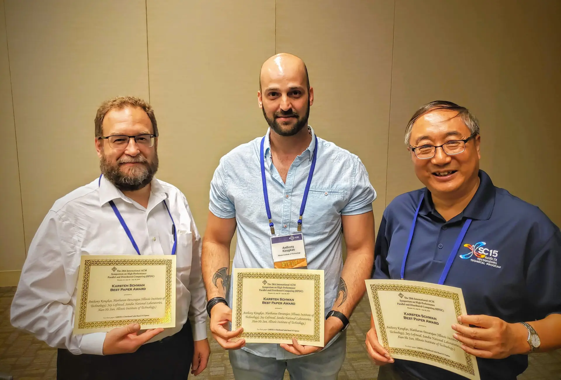 Anthony Kougkas with collaborators Jay Lofstead and Xian-He Sun holding the 2019 HPDC best-paper certificates for LABIOS.